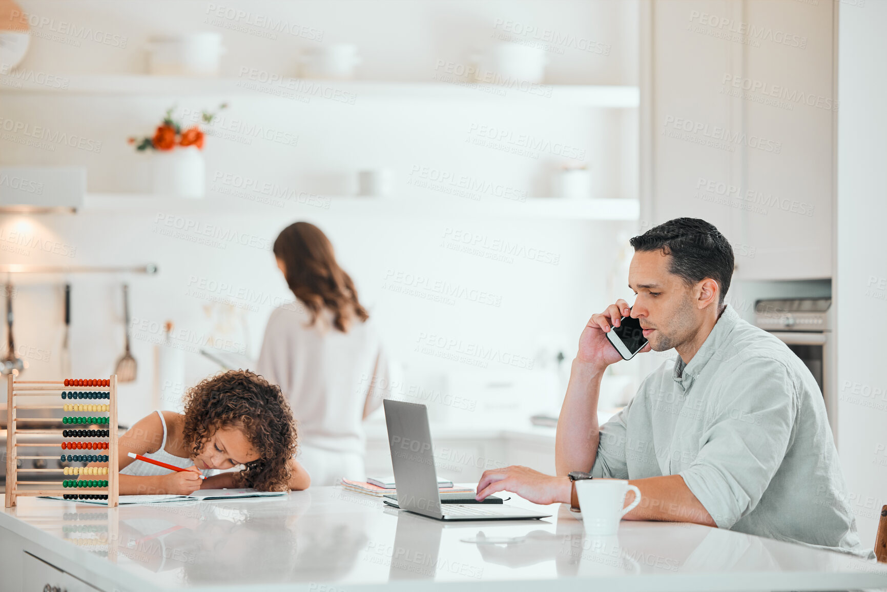 Buy stock photo Shot of a young father working from home while his daughter does homework in the kitchen