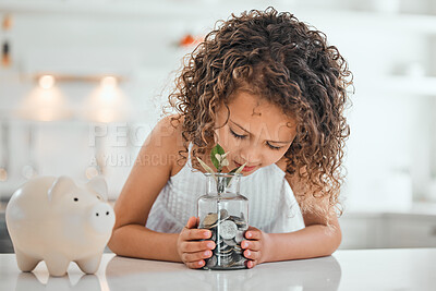 Buy stock photo Shot of a little girl holding a jar filled with coins at home