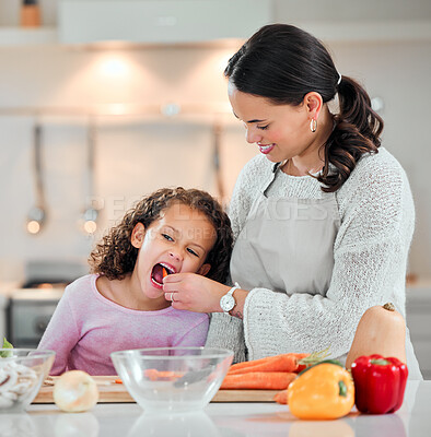 Buy stock photo Shot of a little girl and her mother cooking at home