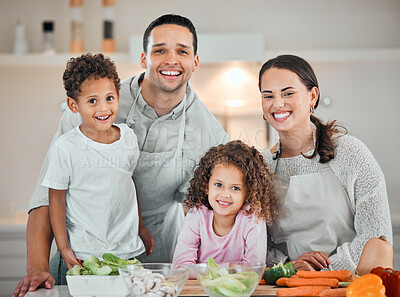 Buy stock photo Shot of a young family cooking food at home