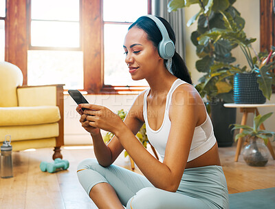 Buy stock photo Headphones, phone and yoga woman listening to meditation music, podcast or wellness audio for mental health. Fitness, exercise and pilates person typing on cellphone for music streaming on mobile app