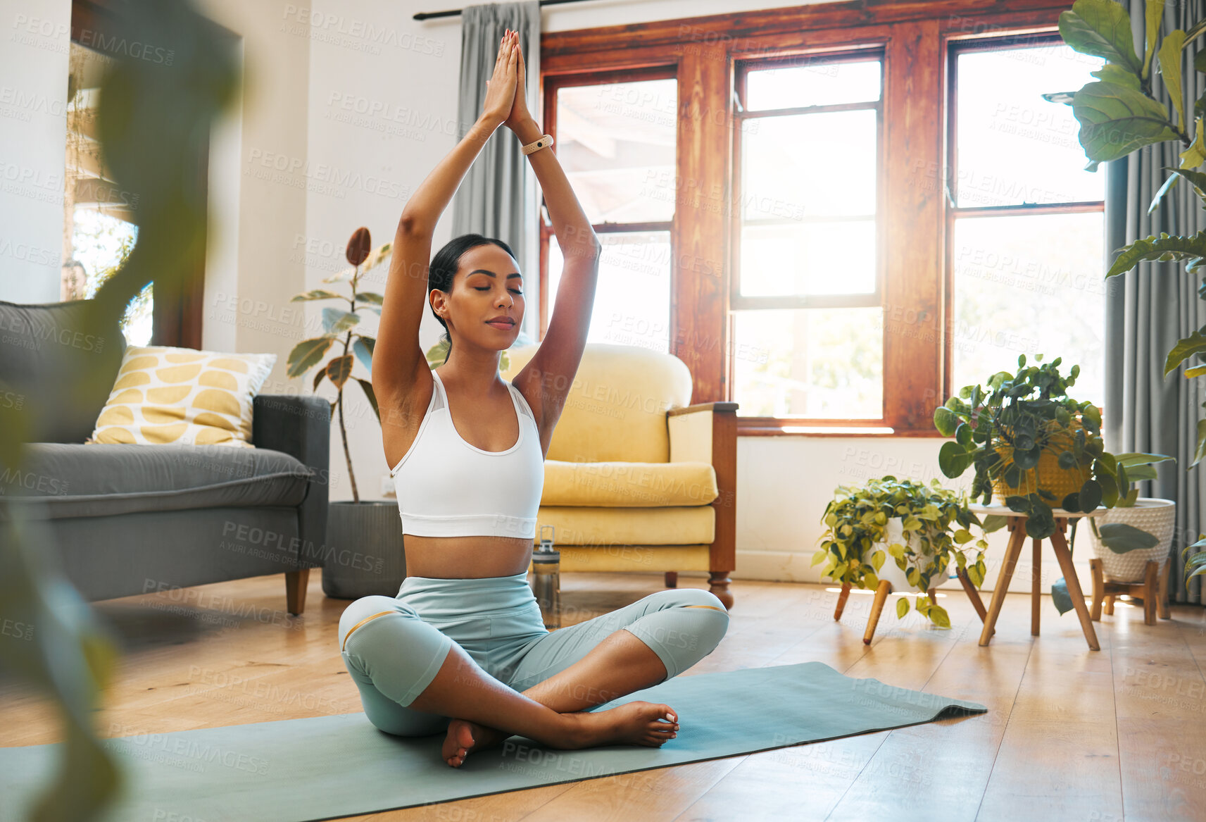 Buy stock photo Yoga, woman and hands above head for meditation, training and exercise at home living room, wellness and holistic health. Calm biracial person meditate, prayer or praying position in pilates workout