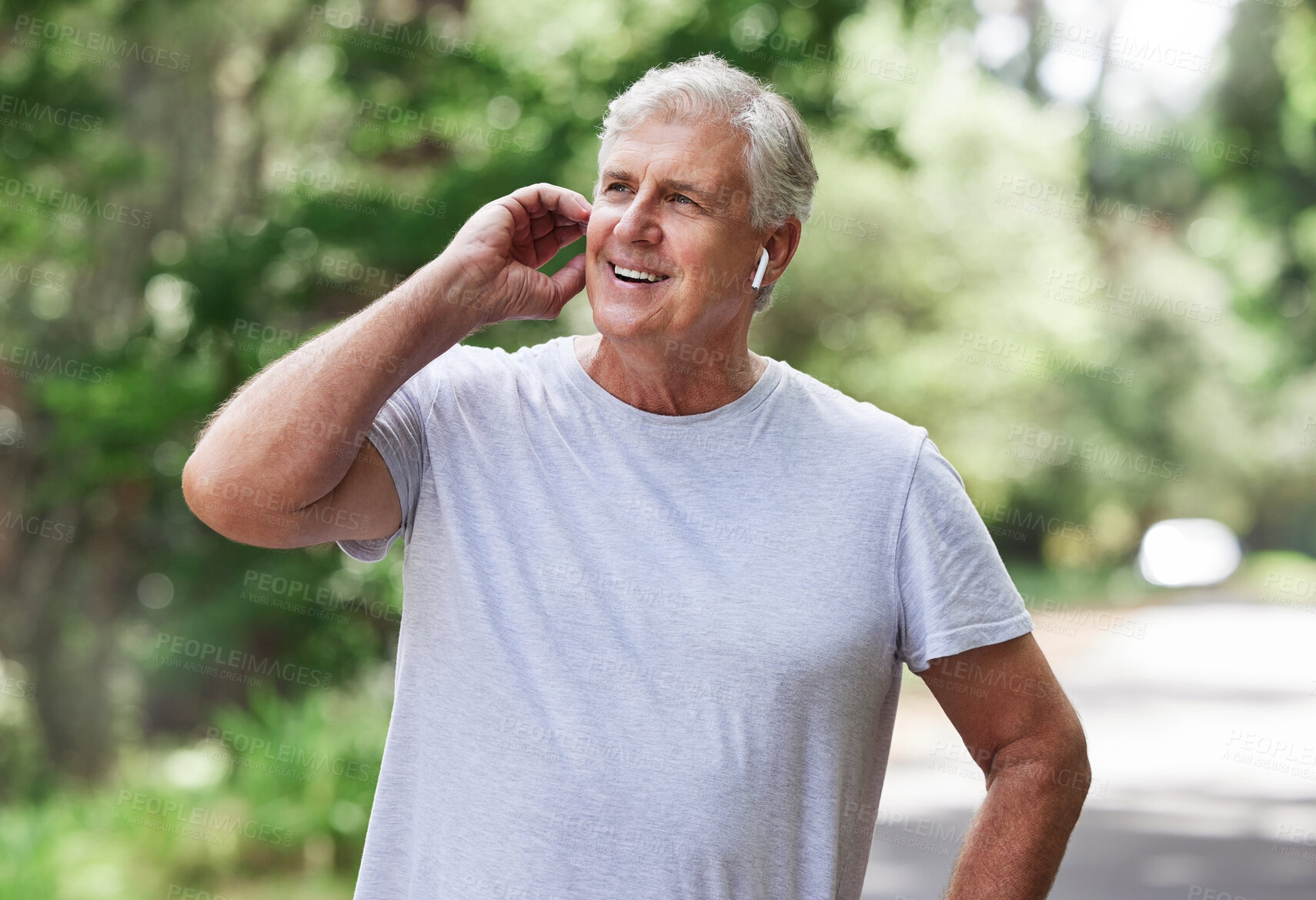 Buy stock photo Thinking, music and man with earphones while running,  fitness motivation and exercise audio. Ready, smile and a senior person laughing while listening to a podcast at a park for cardio and workout