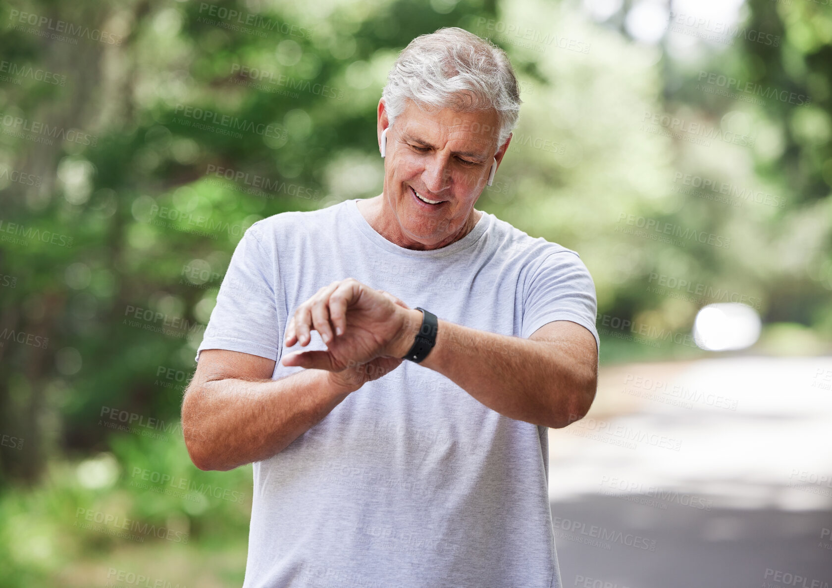 Buy stock photo Senior man, watch and outdoor for exercise time to run, workout and training on road for fitness. Elderly male person  happy about cardio progress for health and wellness while running in summer