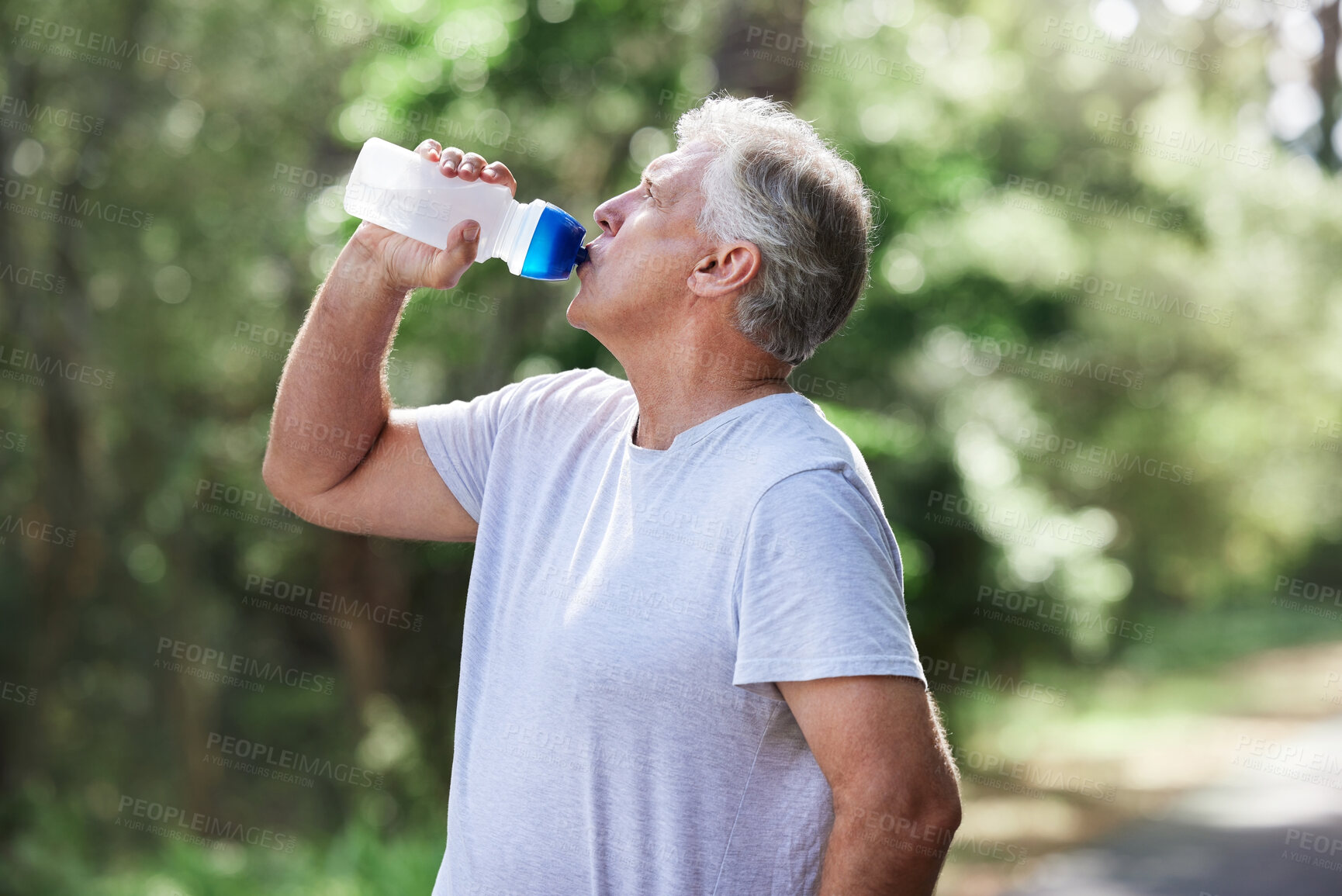 Buy stock photo Man, exercise and outdoor drinking water for a run, workout and training for fitness. Senior male person with bottle for hydration, cardio health and wellness while running in nature and retirement