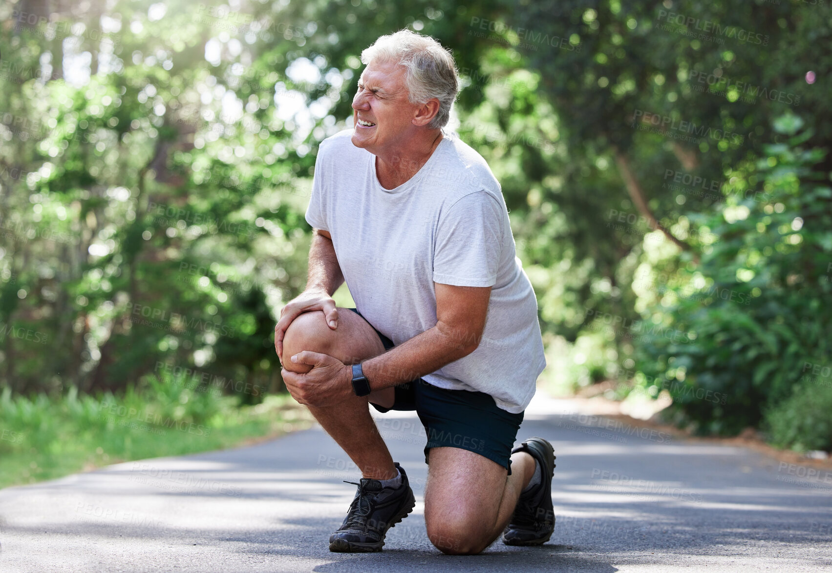 Buy stock photo Running, injury and old man with knee pain on path in nature for outdoor fitness and workout exercise. Health, wellness and muscle strain, senior runner with hand on leg in support or relief for ache