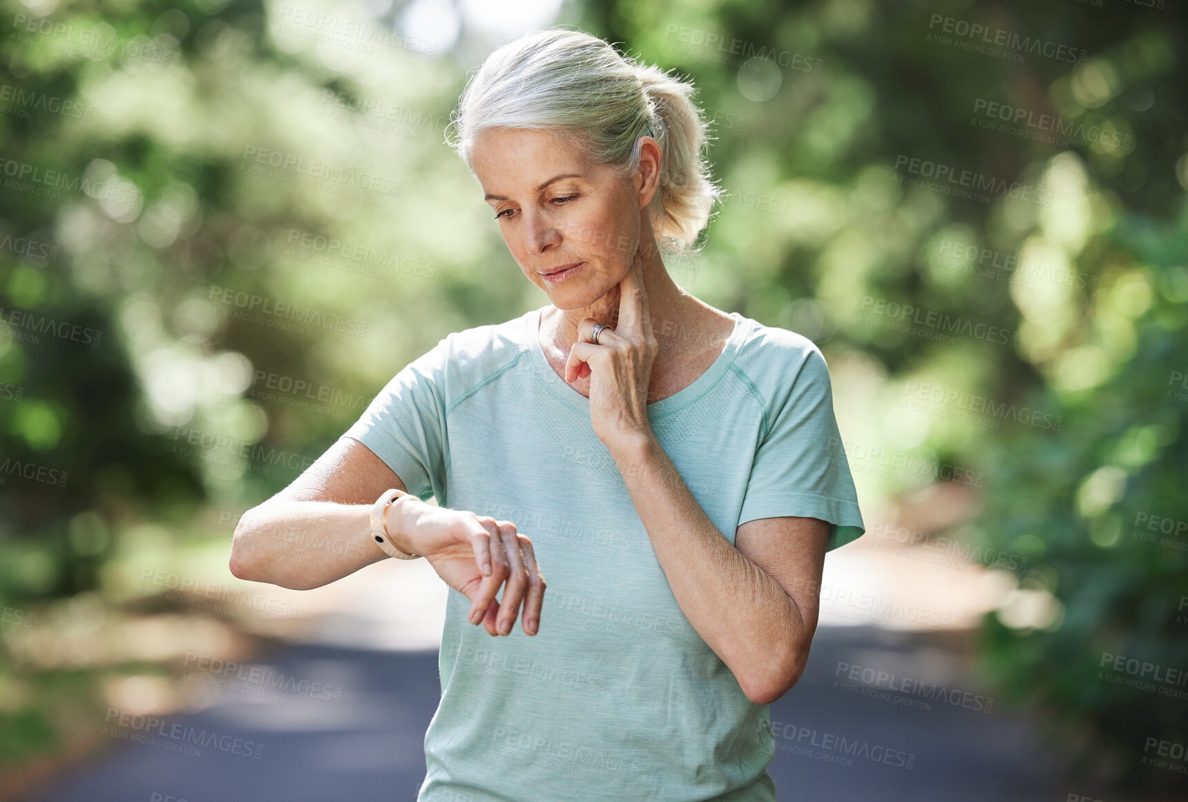 Buy stock photo Senior woman, watch and pulse outdoor for exercise on run, workout and training on road for fitness. Elderly female person check cardio progress time for health and wellness while running in nature