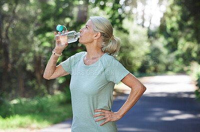 Buy stock photo Fitness, exercise and mature woman drinking water, outdoor and training for balance, fresh air and break. Senior female, nature and lady with aqua, retirement and thirsty after practice and workout