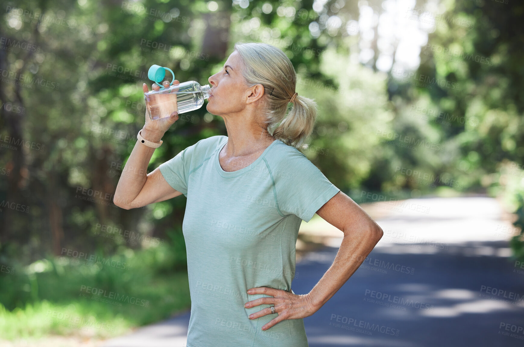 Buy stock photo Fitness, exercise and mature woman drinking water, outdoor and training for balance, fresh air and break. Senior female, nature and lady with aqua, retirement and thirsty after practice and workout