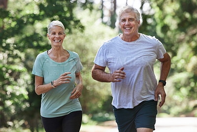 Buy stock photo Senior couple, exercise and running outdoor for happy workout and training for fitness. Elderly man and woman laugh for cardio, health and wellness on run in nature forest for healthy retirement