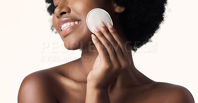 Buy stock photo Black woman, beauty and cotton pad in hand with skincare and natural cosmetics on white background. Cleaning makeup from face, wellness and skin glow, African female model with smile and dermatology