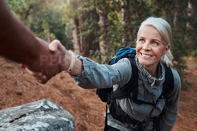 Buy stock photo Hiking, helping hand and people in nature for climbing adventure, senior wellness and support for health. Happy woman or couple of friends hands reaching for teamwork on mountains or forest trekking