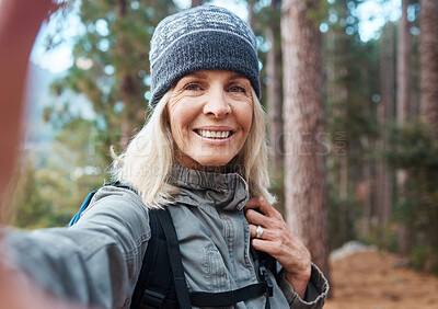 Buy stock photo Selfie, hiking and a senior woman in the forest for fitness, adventure or the exploration of nature. Portrait, travel and exercise with a mature female hiker in the mountains or woods for a hike