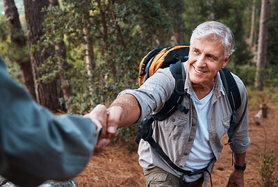 Buy stock photo Help, holding hands and couple hiking in nature, climbing support and giving a hand. Happy, together and a person helping a senior man up a hill while on a walk in the mountains for exercise