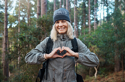 Buy stock photo Portrait, heart and happy woman in forest hiking, fitness and health support, self care hands and cardiovascular workout. Nature, travel or trekking of mature person in woods with love sign or emoji