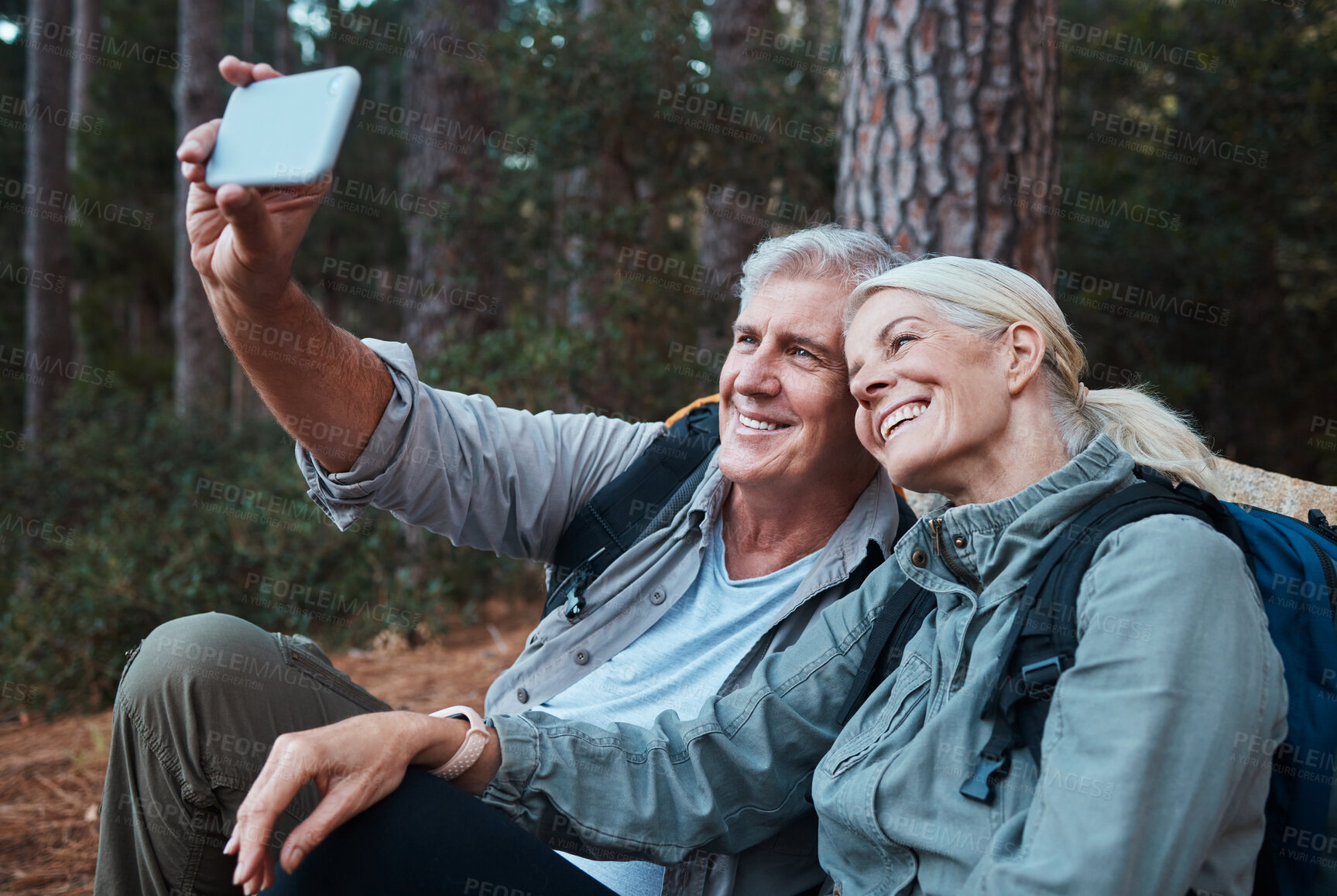 Buy stock photo Senior couple, selfie and hiking in forest, happy people in nature with memory and social media post. Smile in picture, adventure and fitness, old man and woman with active lifestyle and outdoor