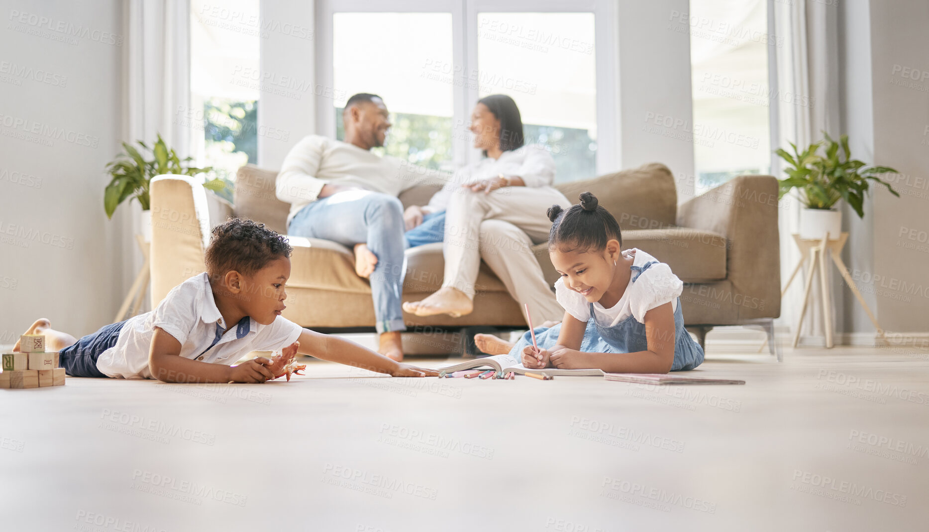 Buy stock photo Relax, family and kids in lounge, happy and learning of children, girl and smile of writing in notebook. Playful, boy and toy on floor, parents and together on couch, joy and rest for weekend in home