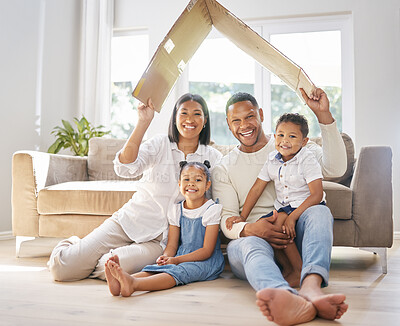Buy stock photo Shot of a family holding a cardboard shaped roof at home