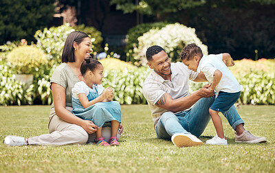 Buy stock photo Shotof a happy young family enjoying a fun day out at the park