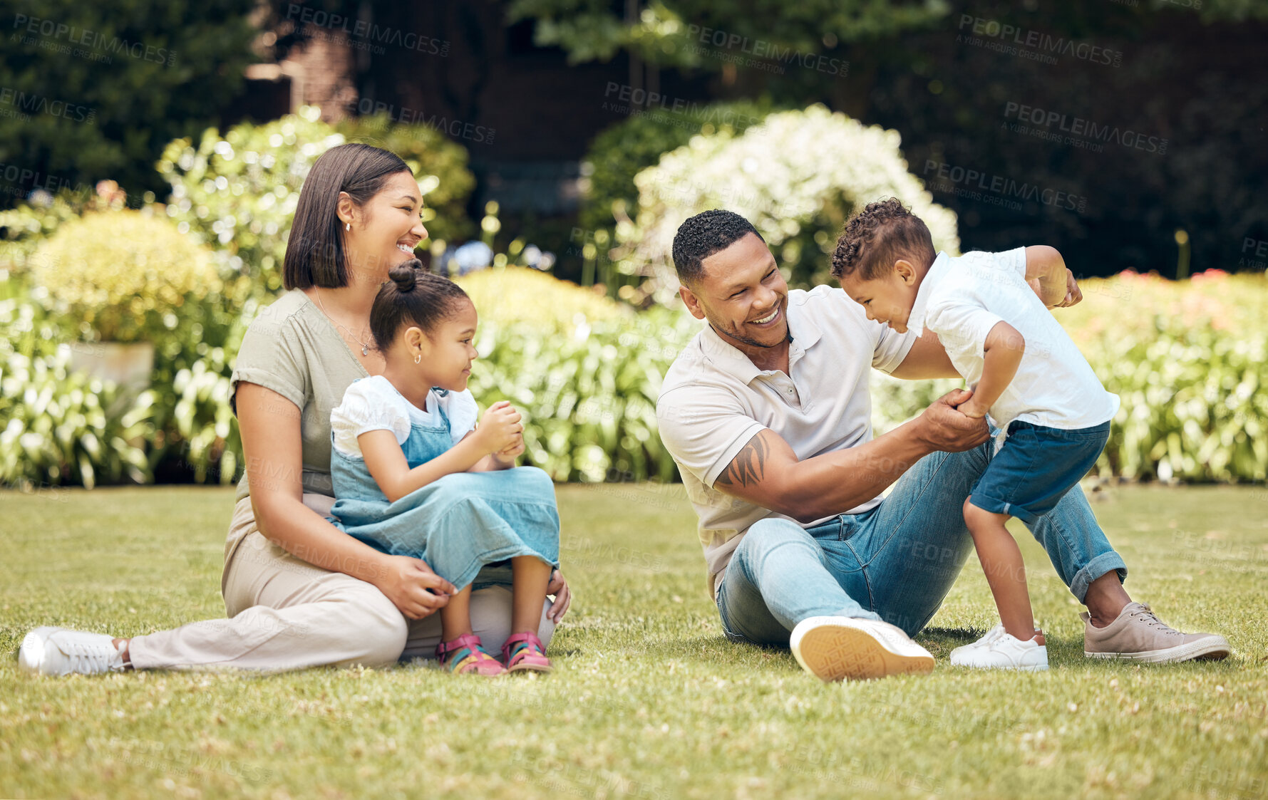 Buy stock photo Family, park and play together for love, freedom and laughing in outdoor nature for comedy. Parents, children and relax on grass for fun or countryside field for bonding, happiness and backyard games