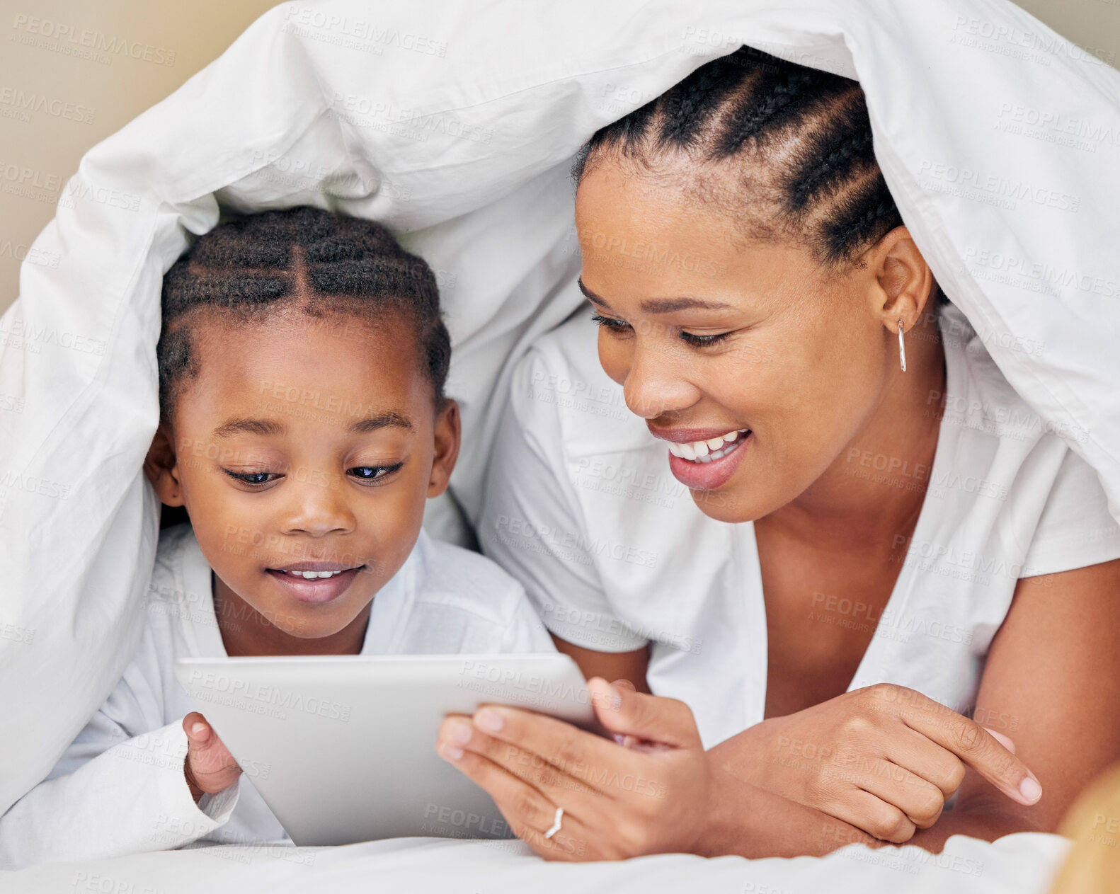 Buy stock photo Black family, blanket and tablet or online in home, bonding and security in relationship or love. Parents, children and duvet for fort or streaming movie in bedroom, morning and online together