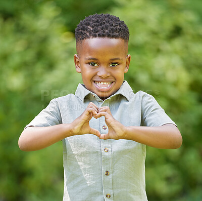 Buy stock photo Boy, portrait and outdoor with heart hands for love in africa with happiness and is excited on the weekend. Male child, face and smile with hearts sign at the park with sun for peace and kindness.