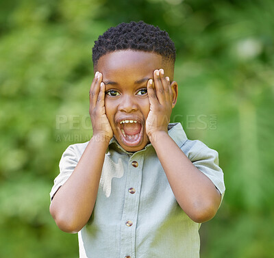 Buy stock photo Shot of an adorable little boy looking surprised while standing outside