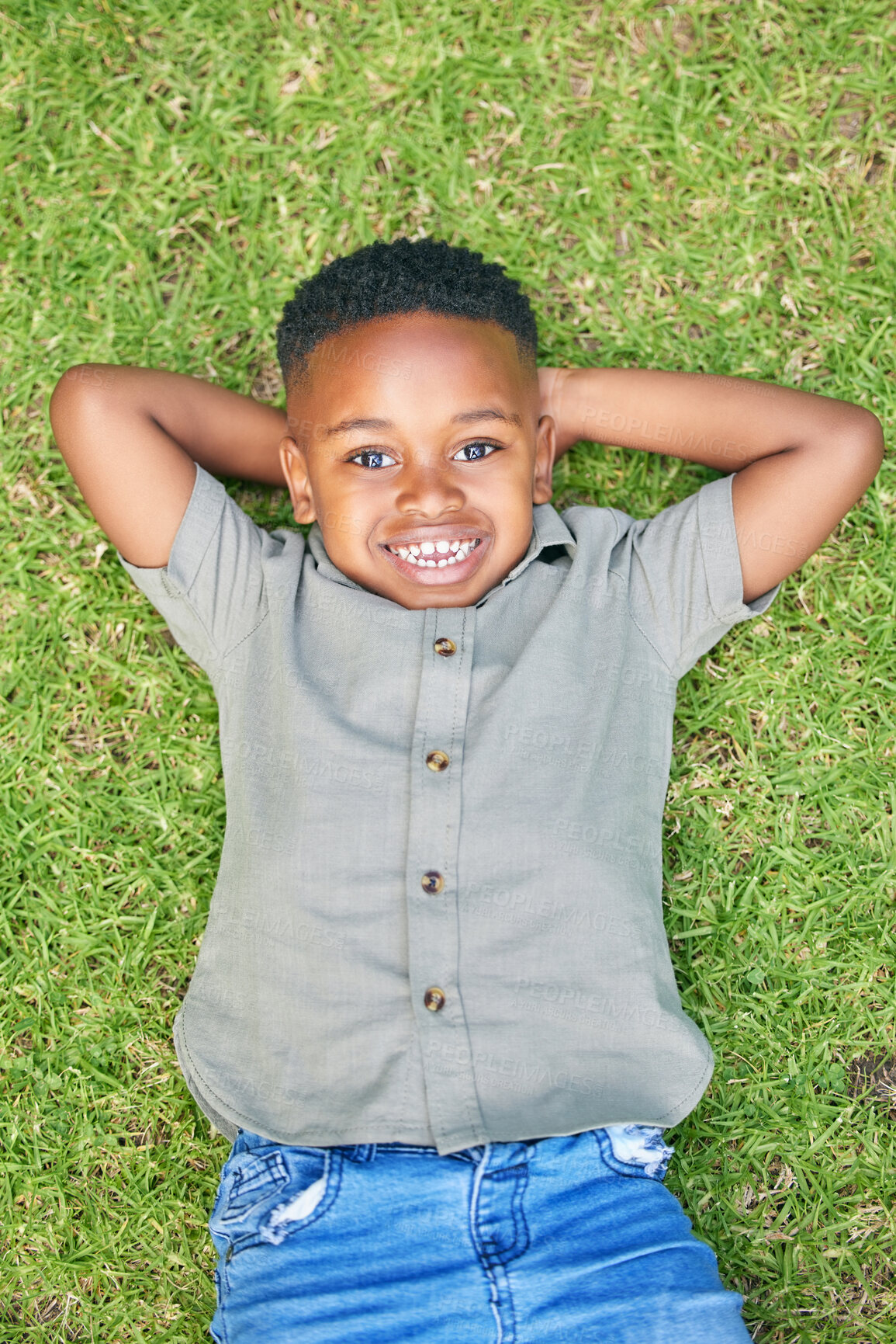 Buy stock photo Above, grass and portrait of black child with smile, summer fashion and happiness in nature. Young boy, relax and rest in backyard for play, school break and fun day in park or field in Nigeria