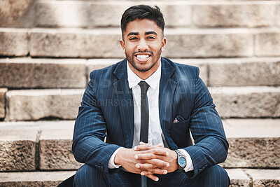 Buy stock photo Cropped portrait of a handsome young businessman sitting on a flight of stairs outside in the city