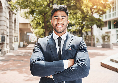 Buy stock photo Cropped portrait of a handsome young businessman standing with his arms folded outside in the city