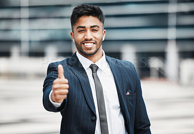Buy stock photo Cropped portrait of a handsome young businessman giving thumbs up while standing outside in the city
