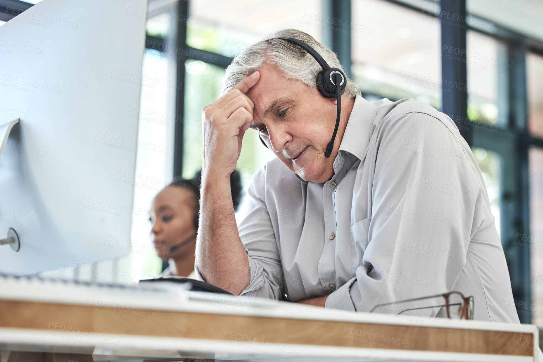 Buy stock photo Stress, callcenter manager and man with headache in customer service agency with pain or crisis. Communication fail, senior management with computer or help desk consultant with problem on phone call