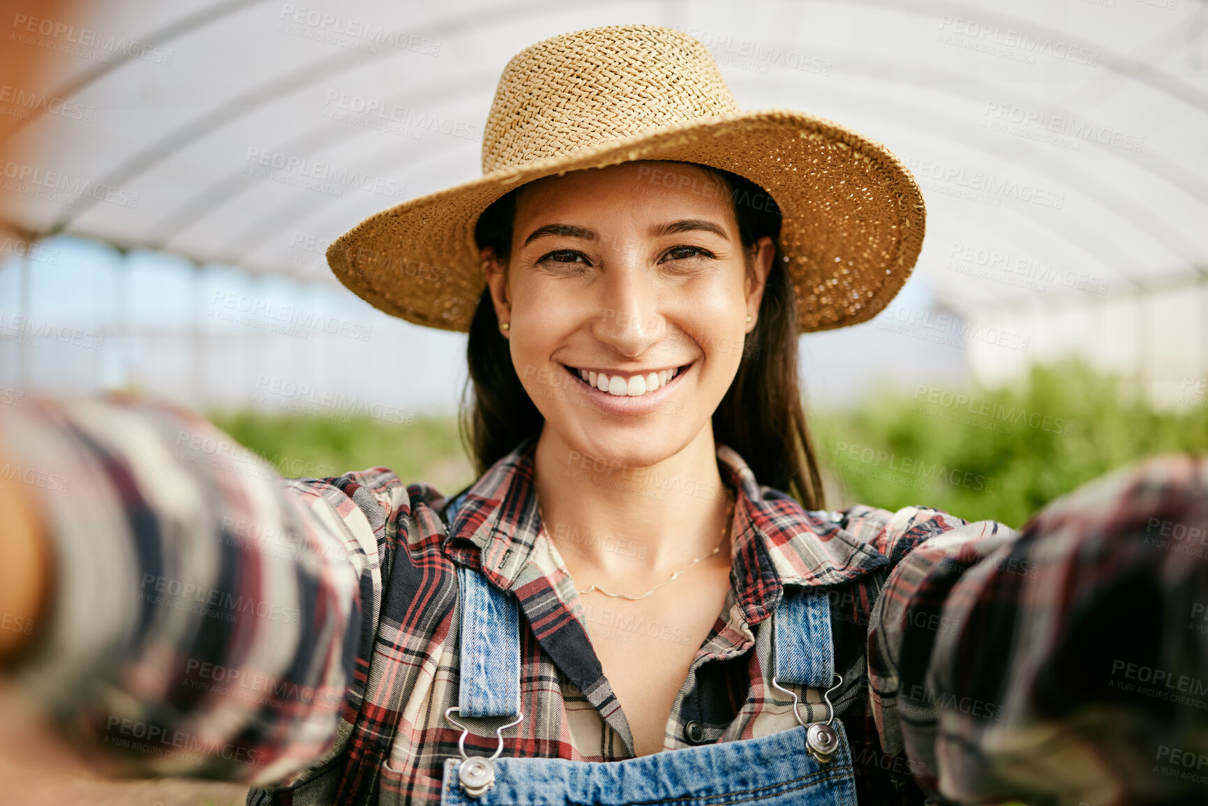 Buy stock photo Shot of a young female farmer taking selfies