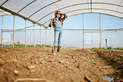 Buy stock photo Shot of a young female farmer looking tired after a day of hard work on her farm