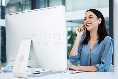 Buy stock photo Shot of a young call centre agent working on a computer in an office