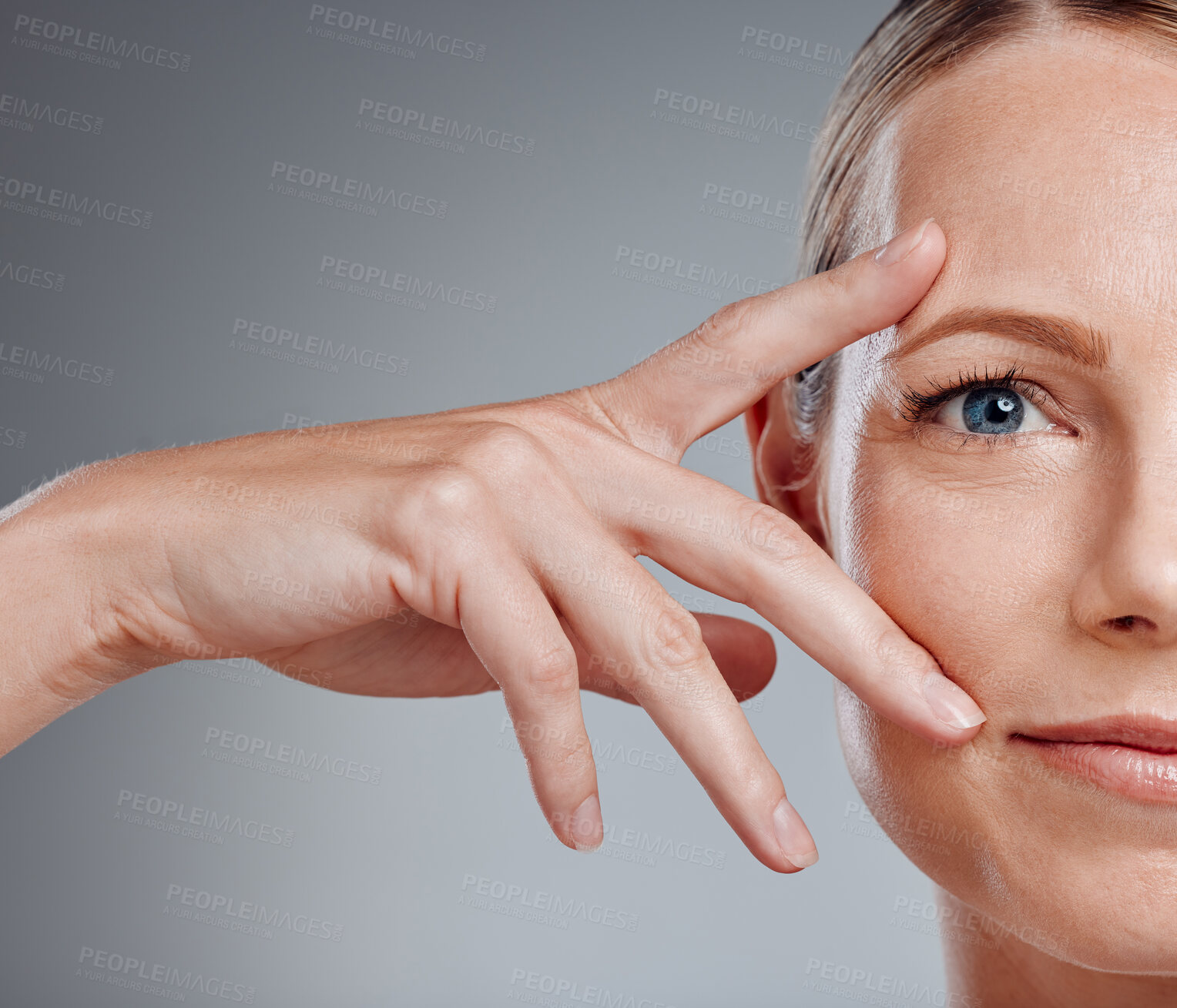 Buy stock photo Beauty, hand and portrait of woman in studio on gray background for facial cosmetics. Half face, skincare and wellness with confident person at salon or spa for antiaging dermatology treatment