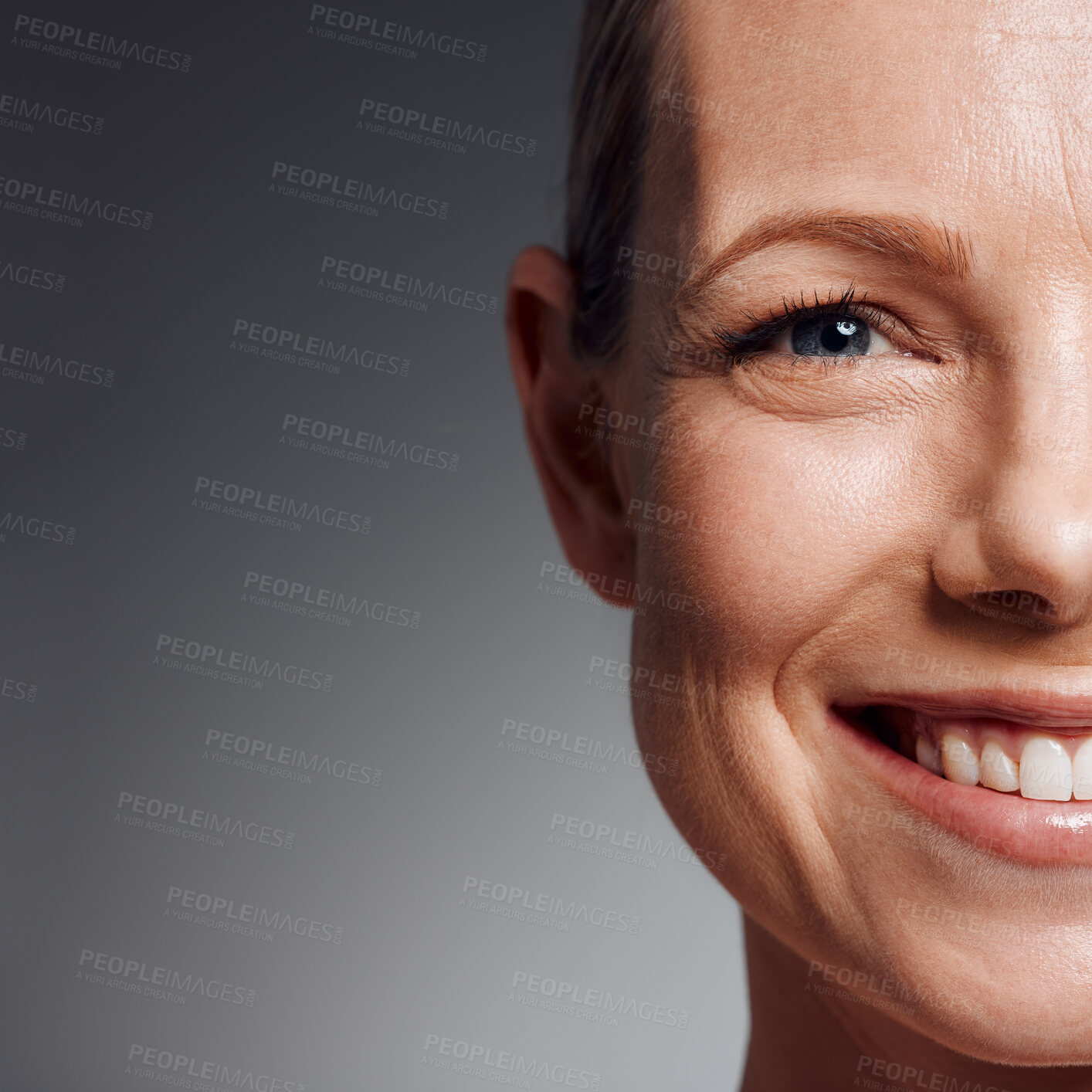 Buy stock photo Portrait, skincare and smile of mature woman in studio on gray background for facial cosmetics. Beauty, half face and space with confident person on mockup for antiaging dermatology treatment