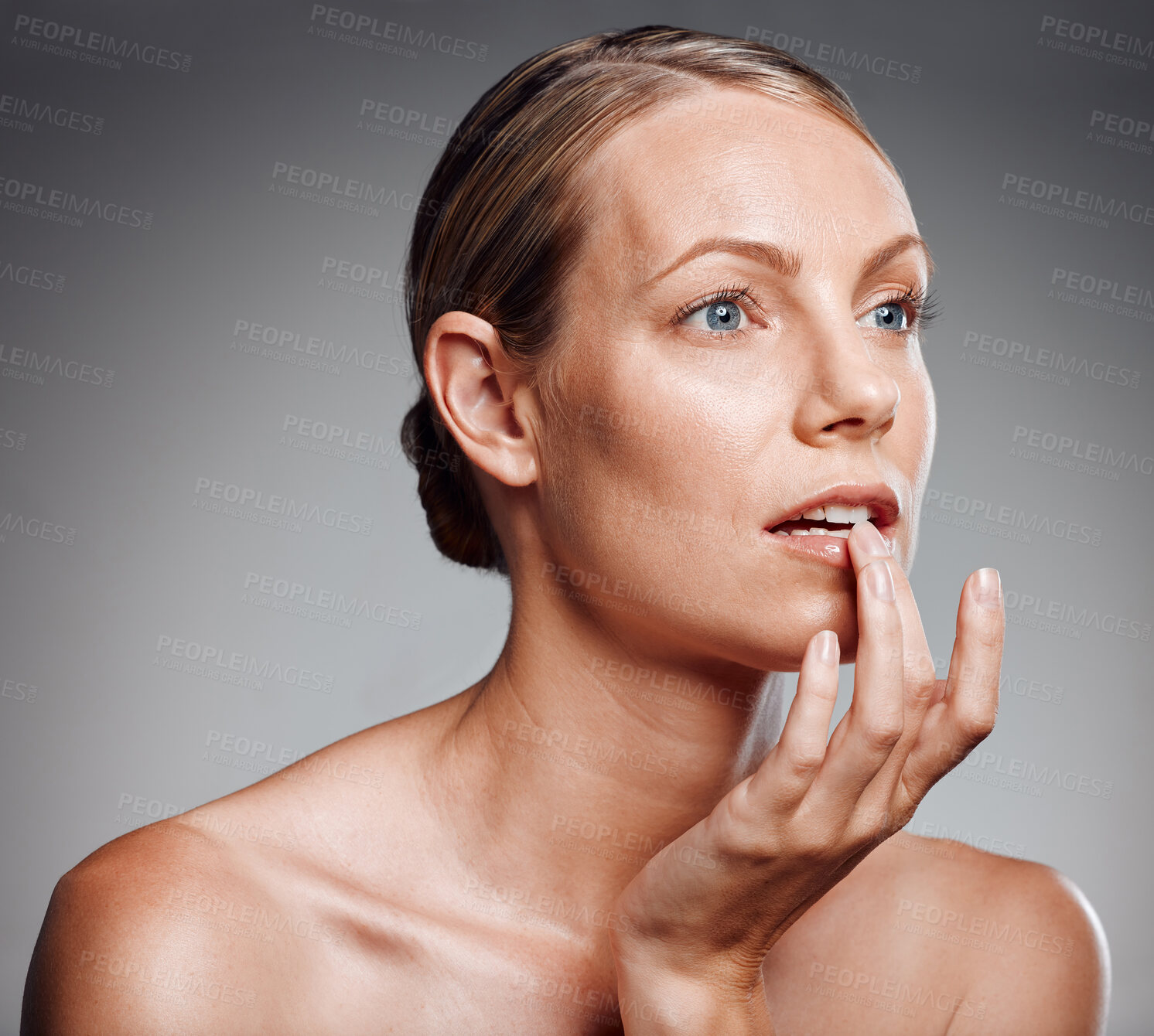 Buy stock photo Skincare, mature woman and touch lips for hydration, moisturizer and natural cosmetics. Beauty, model and hand on mouth for treatment, dermatology or collagen for anti aging on gray studio background