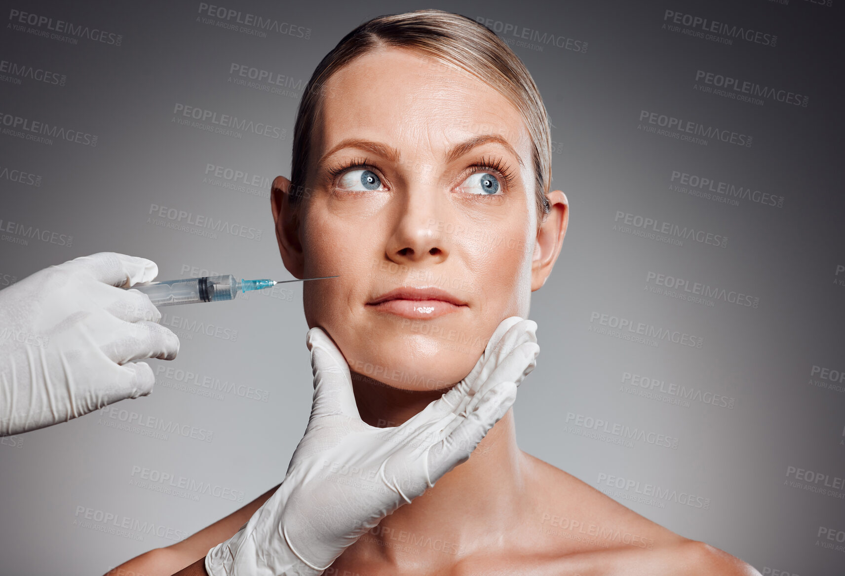 Buy stock photo Beautiful mature woman getting botox injection in studio against a grey background