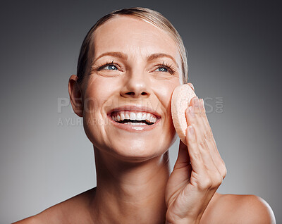 Buy stock photo Beautiful mature woman exfoliating her face in studio against a grey background