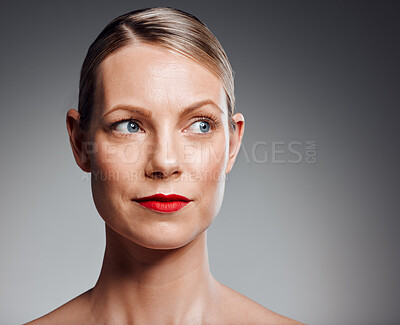 Buy stock photo Thinking, beauty and mature woman with makeup for glow, results or serious on gray studio background. Face, skincare and model in red lipstick for cosmetics, dermatology or anti aging and aesthetic