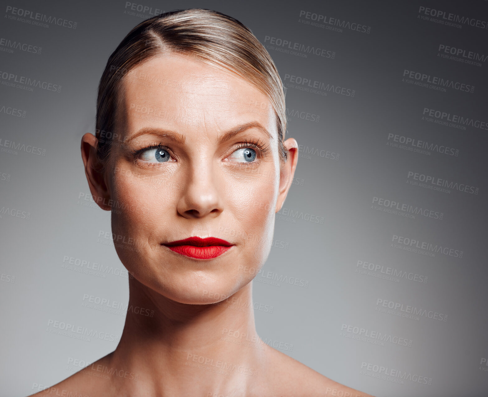 Buy stock photo Thinking, beauty and mature woman with makeup for glow, results or serious on gray studio background. Face, skincare and model in red lipstick for cosmetics, dermatology or anti aging and aesthetic