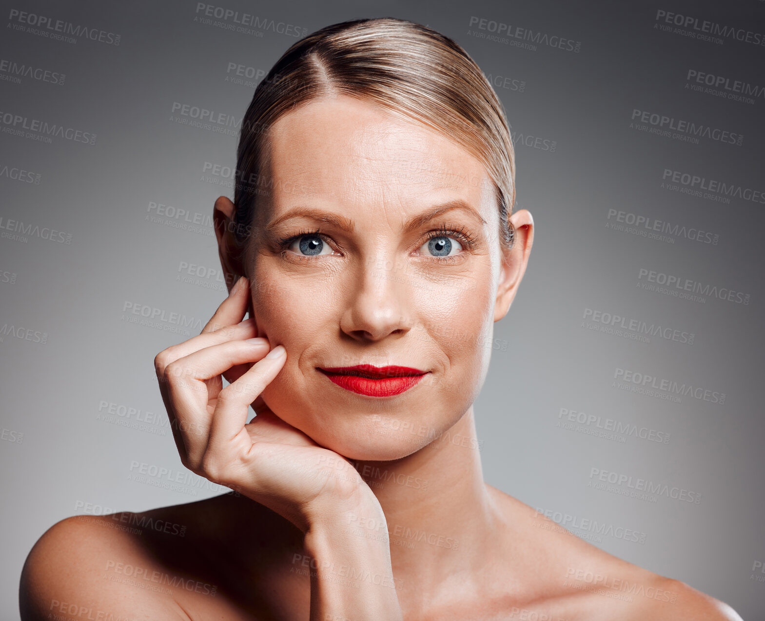 Buy stock photo Portrait, beauty and mature woman in makeup for glow, skincare results or dermatology. Face, touch and model with red lipstick for cosmetics, anti aging and aesthetic at spa on gray studio background