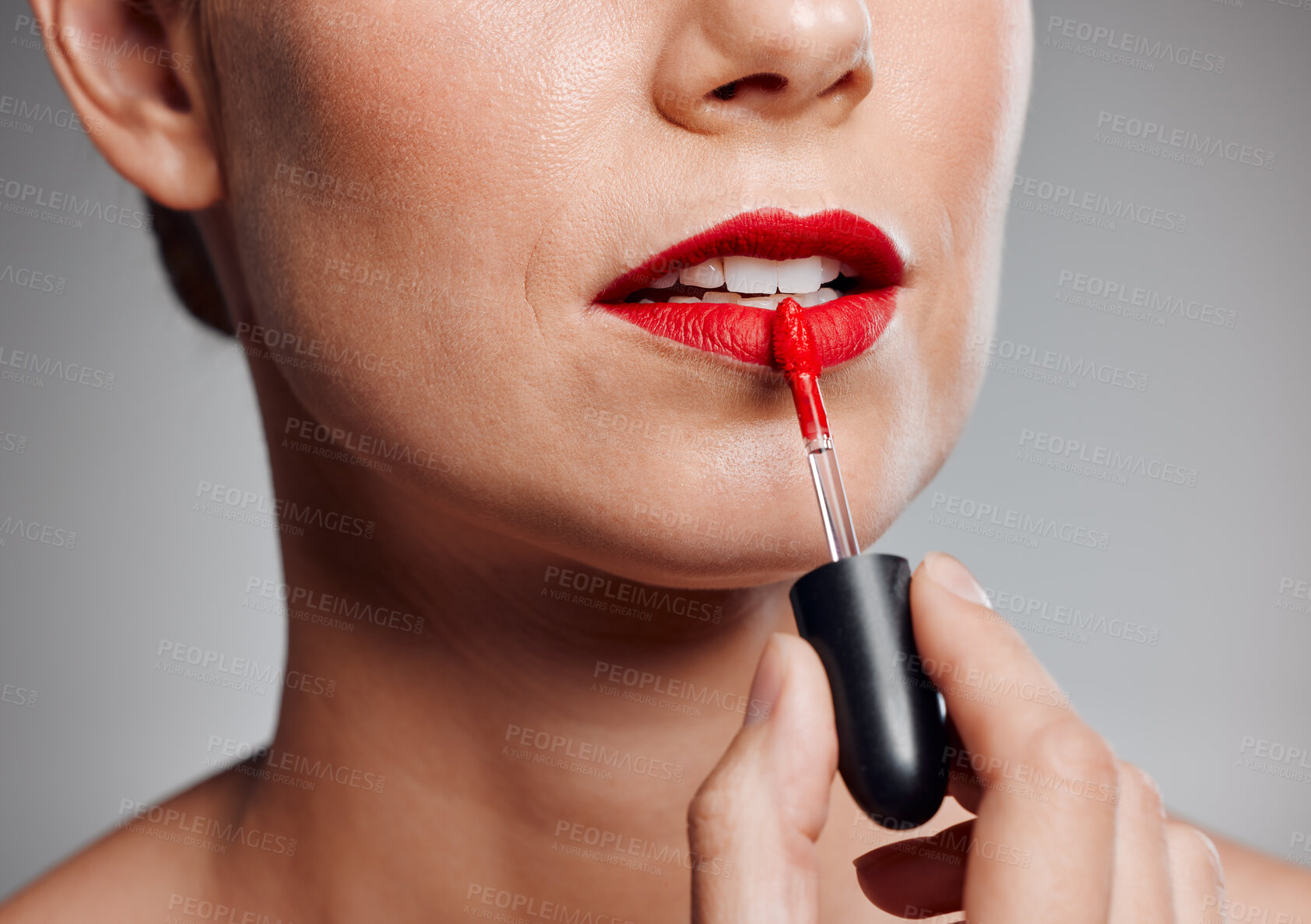 Buy stock photo Woman, mouth and apply lipstick in studio, red color and makeup cosmetics on gray background. Female person, wand and dermatology tool for grooming or treatment, luxury product and skincare closeup