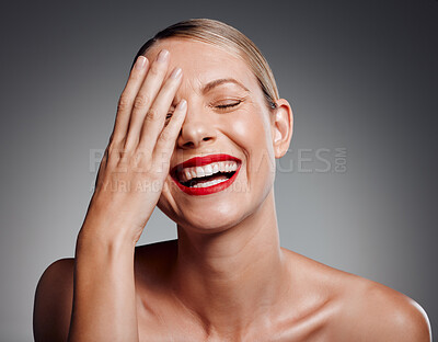 Buy stock photo Laughing, lipstick or skincare of mature woman in studio for glow, results or funny joke on gray background. Face, elegant or happy model with beauty cosmetics for confidence, silly humor or wellness