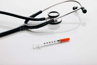 Buy stock photo Stethoscope, healthcare and needle in studio, medical and injection for treatment, heartbeat and medicine. Space, wellness and syringe for immunization, protection and prevention of virus in clinic