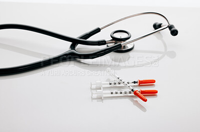 Buy stock photo Stethoscope, healthcare and needle in studio, tools and injection for treatment, heartbeat and medicine. Space, wellness and syringe for immunization, protection and prevention of virus in clinic