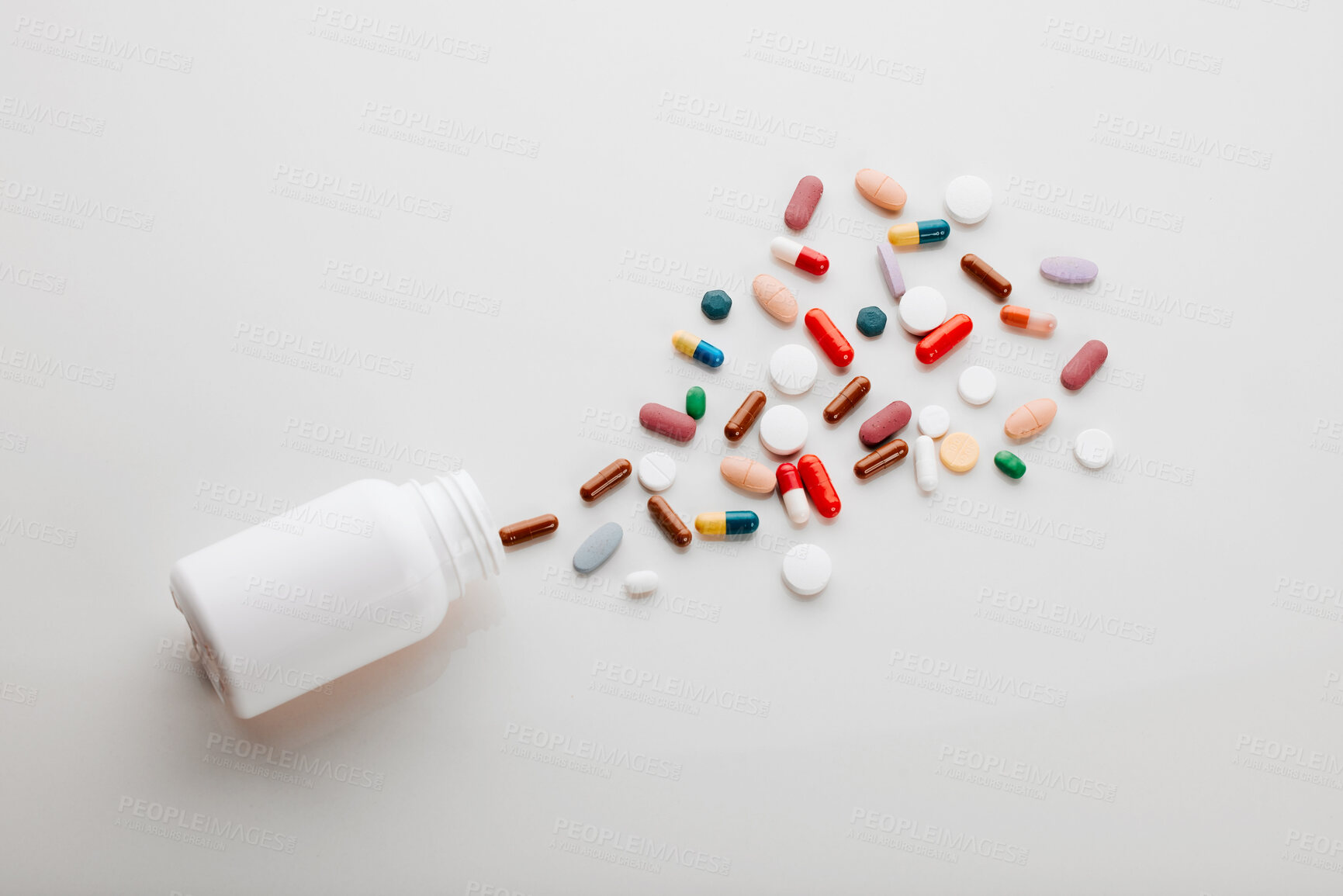 Buy stock photo Pills, above and healthcare in studio, medicine and supplements with vitamins, medical and clinic. White background, pouring and top view of container, pharmaceutical and painkillers in mockup space