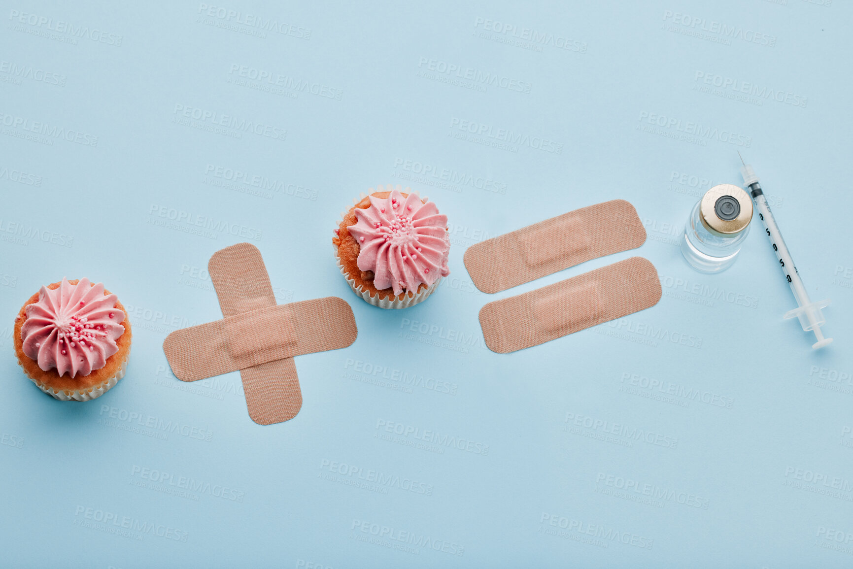 Buy stock photo Plaster, medical and healthcare in studio, injection and protection for wound care, insulin and diabetes. Blue background, treatment and prevention of infection, cupcakes and bandage in hospital