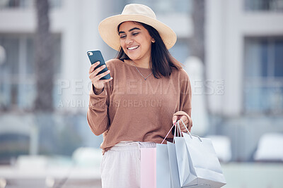 Buy stock photo Shopping, phone and Indian woman in city with bag online for bargain notification, social media and internet. Retail, fashion and female person on smartphone for chat, mobile app and website sale